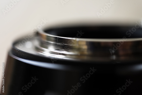 Macro photo of the metal ring on the back of a lens that connects to the camera. Background image, shallow deoth of field photo