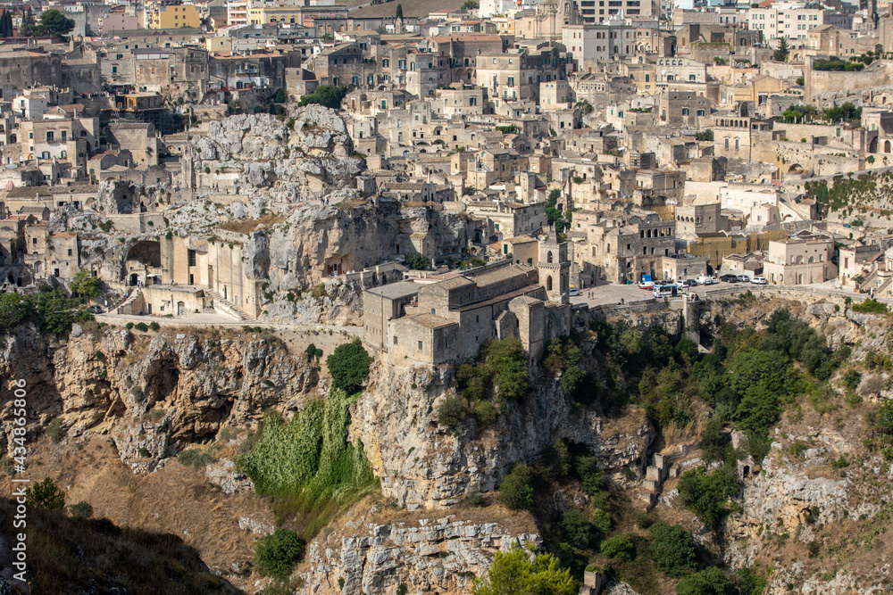 Obraz premium Panoramic view of Sassi di Matera a historic district in the city of Matera, well-known for their ancient cave dwellings from the Belvedere di Murgia Timone, Basilicata, Italy