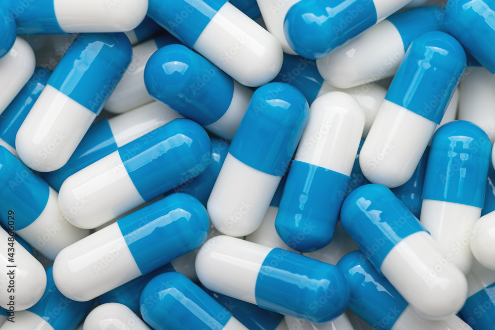 Double white and blue capsules of pharmaceutical medicine, medicinal