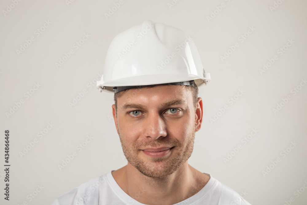 Portrait of a man in a white hard hat. Mock-up. - obrazy, fototapety, plakaty 