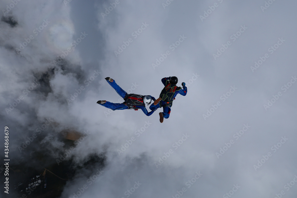 Skydiving. Relative work. Two skydivers are training in the sky. Skydiving. Relative work. Two skydivers are training in the sky.