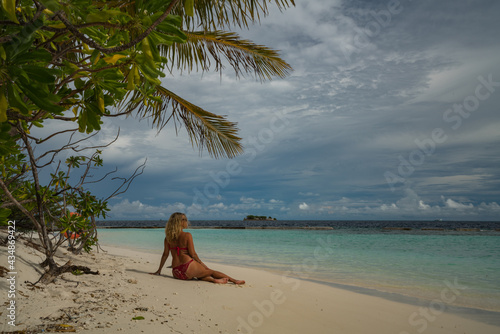 Woman in bikini on the beach on an island in the Maldives © Venko