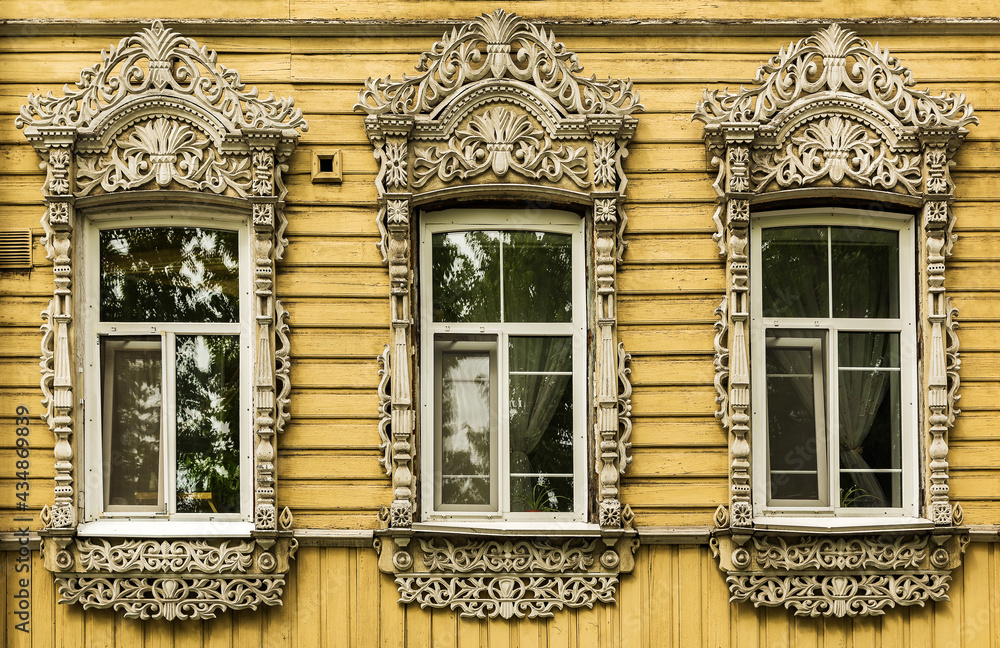 Windows with carved platbands of an old wooden house