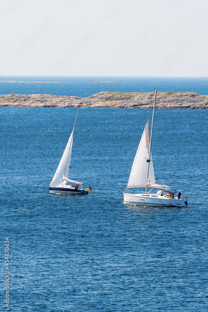 Fototapeta premium Two sailboats sailing on the sea