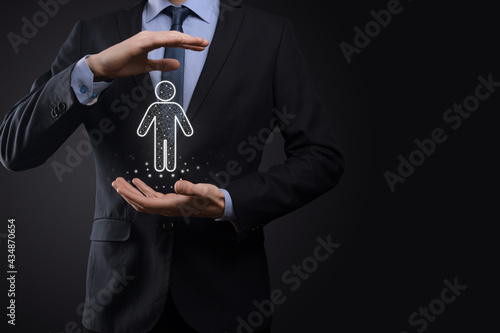 Businessman holds man person icon on dark tone background.HR Human ,people iconTechnology Process System Business with Recruitment, Hiring, Team Building. Organisation structure concept photo