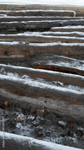 Driftwoods on Beach Covered with Snow