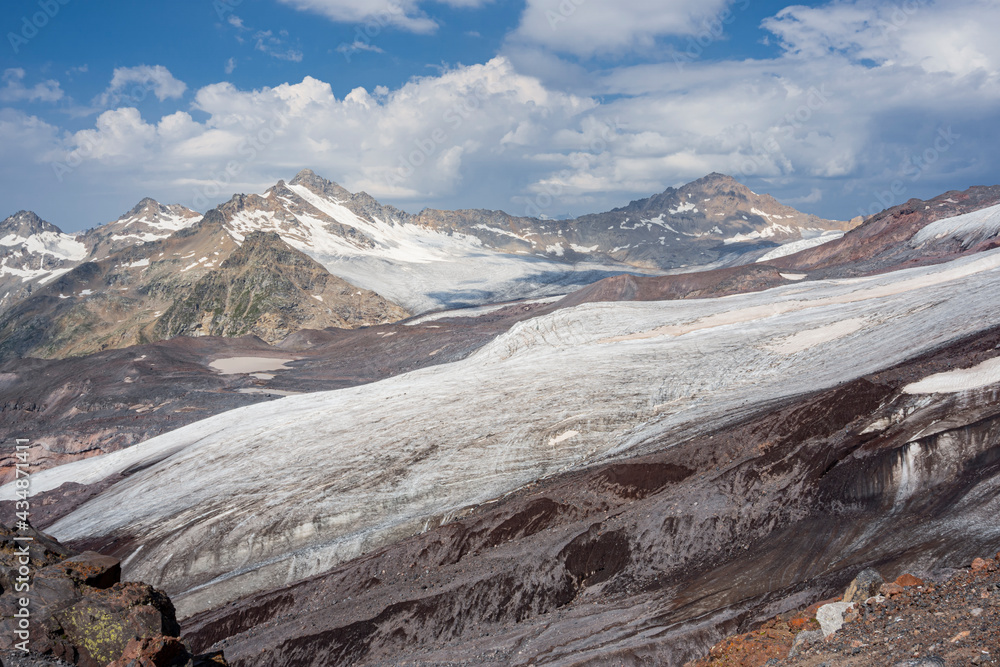Panoramic view of the Elbrus glaciers. In the foreground we can see the tongue of Maly Azau glacier. Southwest side of Elbrus. Altitude 3500 m. July 2020
