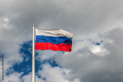 Flag of the Russian Federation on the background of a cloudy sky