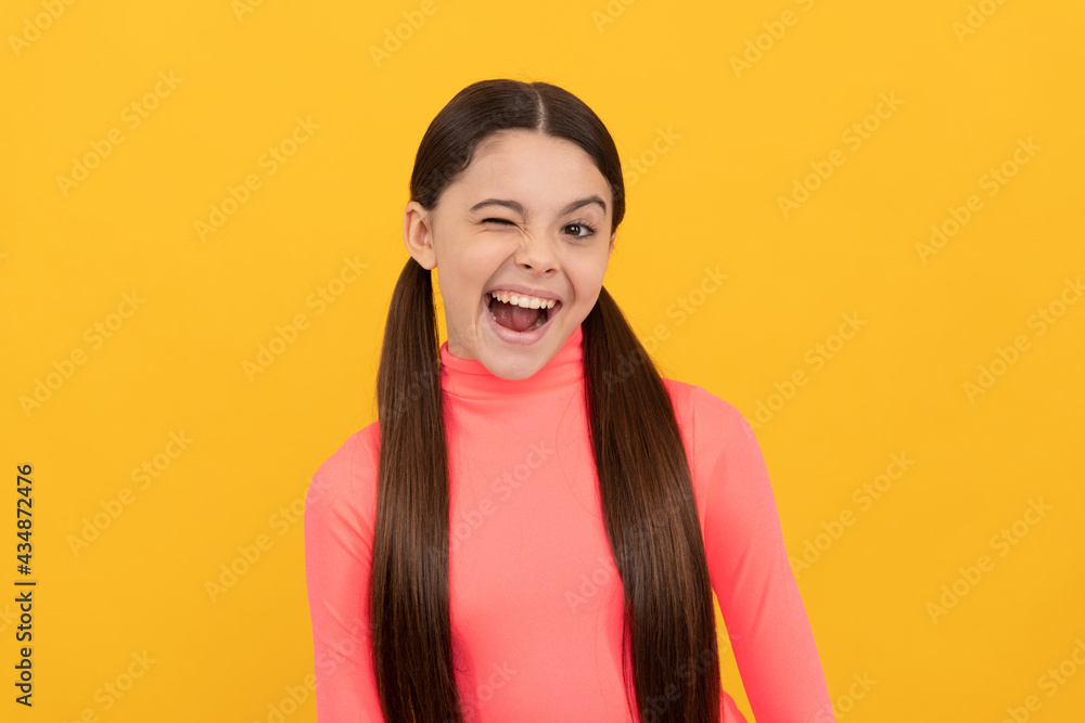 pretty look of young teen girl on yellow background. portrait of happy child. express emotions pretty look of young teen girl on yellow background. portrait of happy child. express emotions