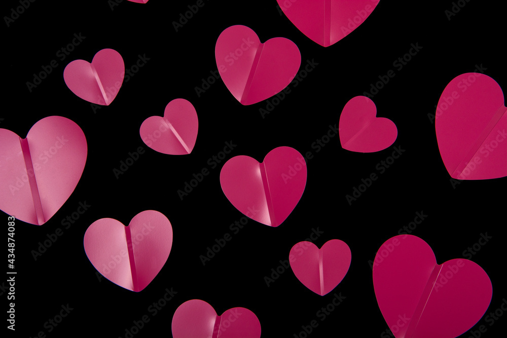 Pink hearts on a black background.