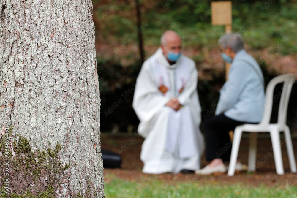 Catholic church during covid19 epidemic. A penitent confessing his