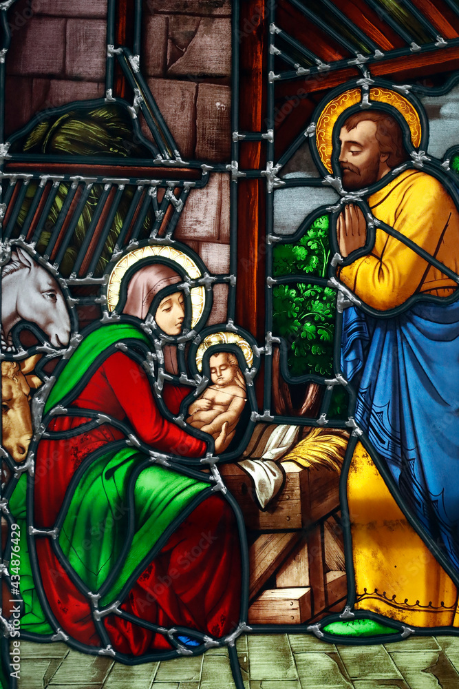 Obraz premium Notre Dame ( our Lady ) d'Aix les Bains church. Stained glass window. Nativity scene. Holy family with baby Jesus. Aix les Bains. France.
