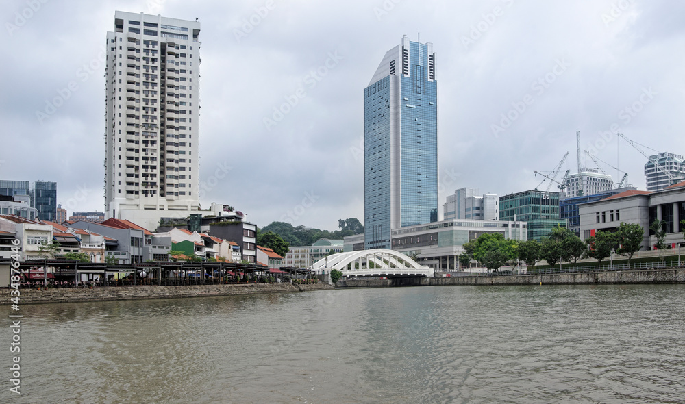 View of Elgin Bridge on the Singapore River. On the bridge pedestrians, on the river ship View of Elgin Bridge on the Singapore River. On the bridge pedestrians, on the river ship