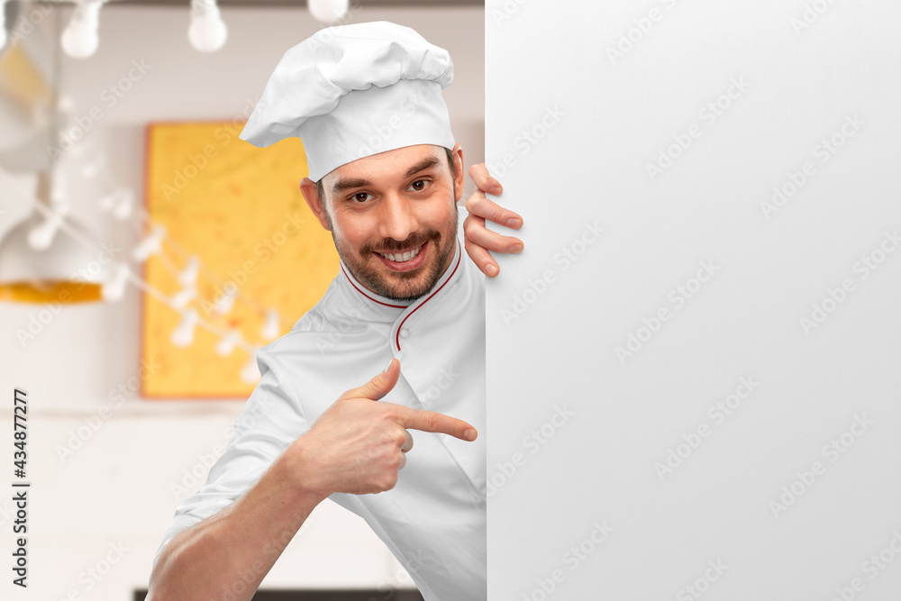 cooking, culinary and people concept - happy smiling male chef in toque pointing finger to big white board over restaurant background cooking, culinary and people concept - happy smiling male chef in toque pointing finger to big white board over restaurant background