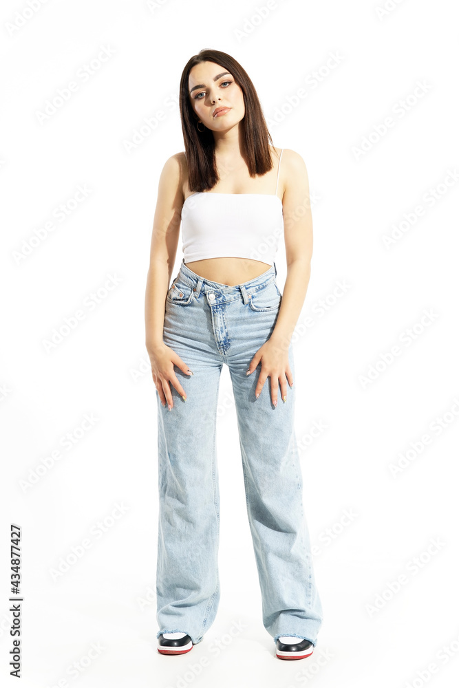 Cool trendy confident gen Z beauty girl looking at camera in stylish clothes. Full body length isolated on white background Cool trendy confident gen Z beauty girl looking at camera in stylish clothes. Full body length isolated on white background