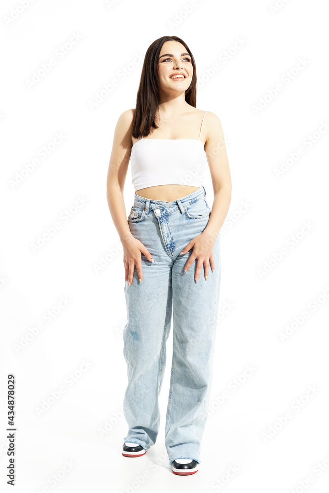 Excited young gen Z woman in summer trendy clothes looking up watching. Full body length isolated on white background Excited young gen Z woman in summer trendy clothes looking up watching. Full body length isolated on white background