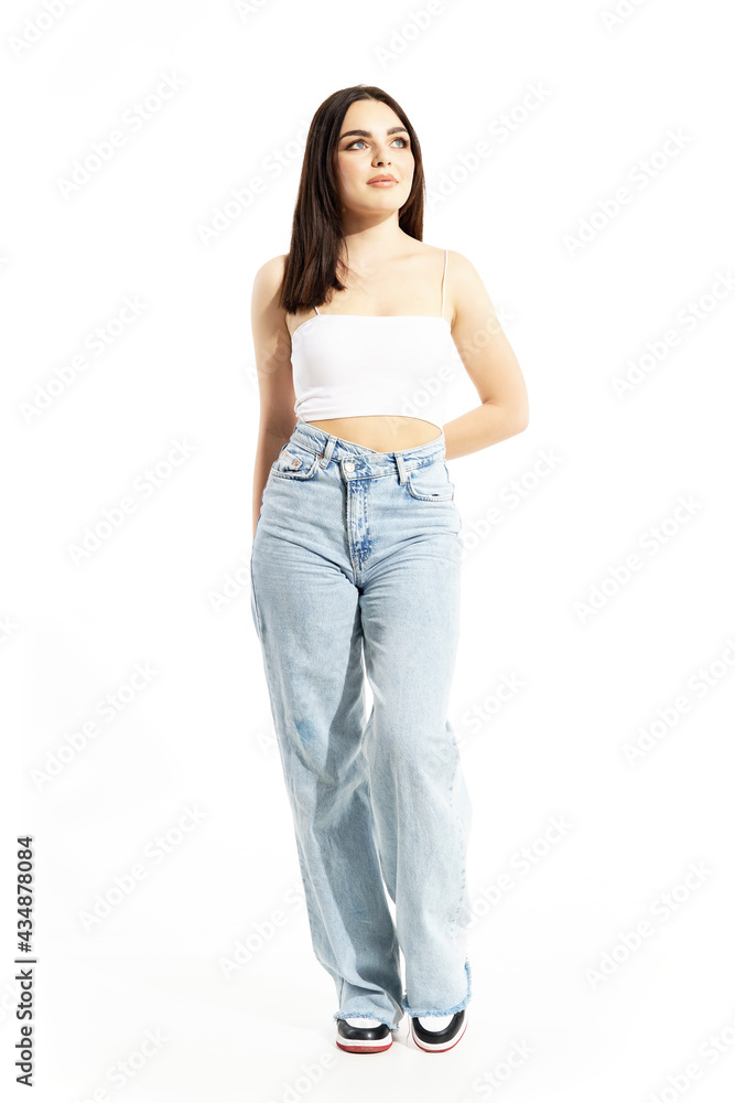 Calm summer street style girl standing and looking up. Full body length isolated on white background Calm summer street style girl standing and looking up. Full body length isolated on white background