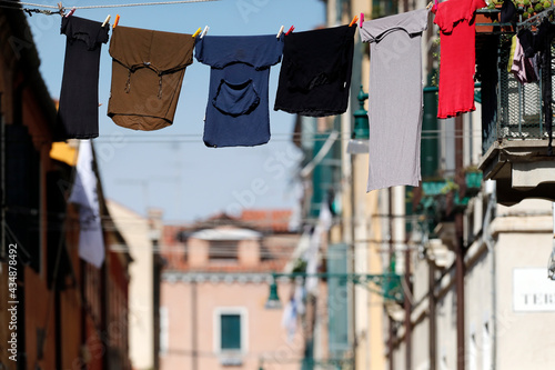 Typical view the streets of Venice washed clothes drying on cords outside the building.