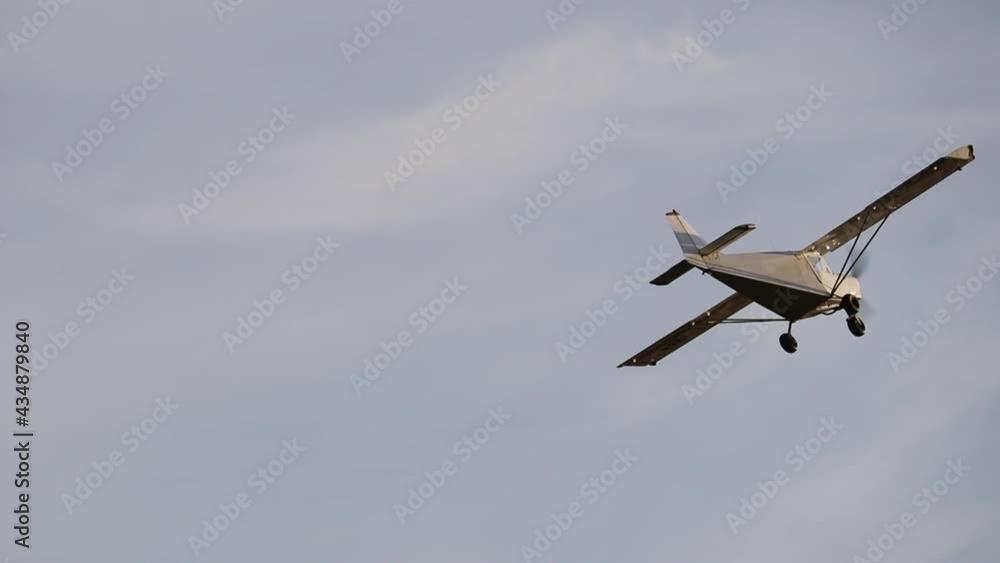 Small private single-propeller plane flying over the blue sky. Agricultural aviation. Small private single-propeller plane flying over the blue sky. Agricultural aviation.