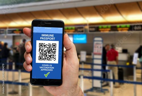 Digital Covid-19 immunity certificate on germany airport check-in counter background.