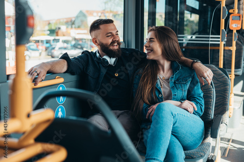 Couple sitting in a bus while talking and flirting