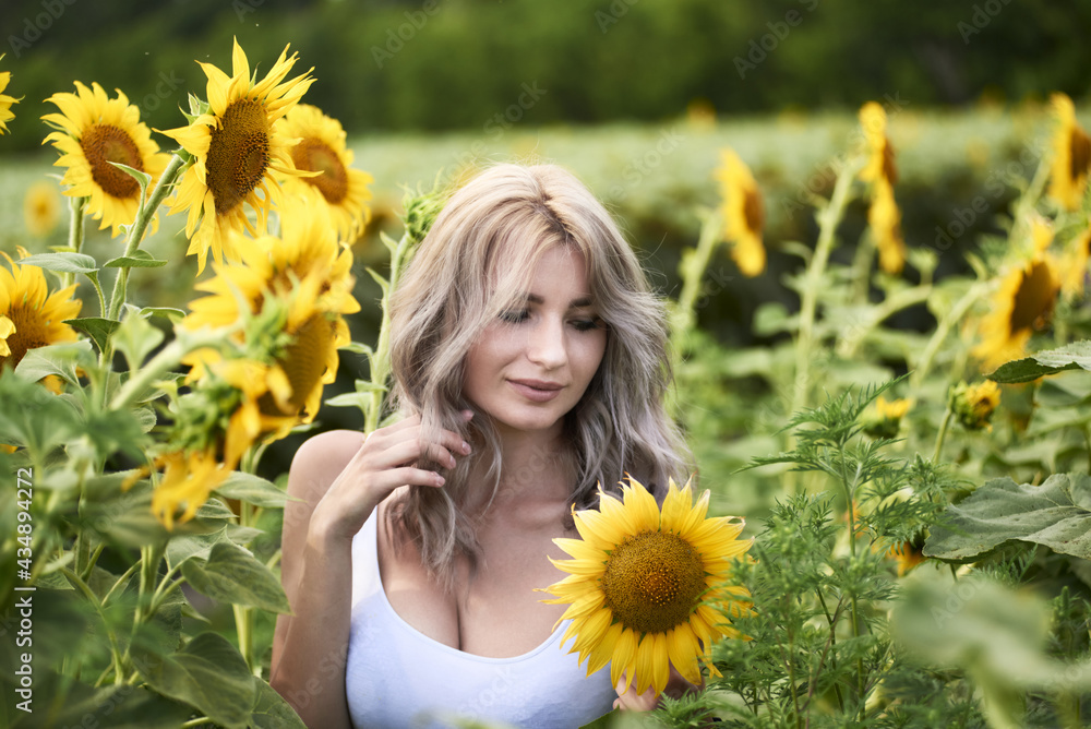 Young woman in sunflower field enjoying nature, Ukraine Young woman in sunflower field enjoying nature, Ukraine