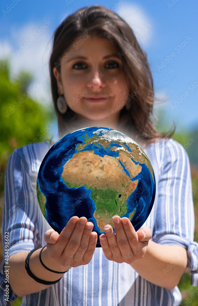 Pretty young woman holding globe on her hands. Environment conservation and energy saving. Ecology and save the planet concept Pretty young woman holding globe on her hands. Environment conservation and energy saving. Ecology and save the planet concept