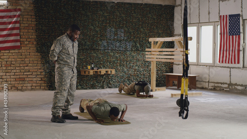 Black commander instructing soldier during training