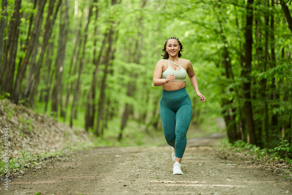 Plus size runner woman in the forest Plus size runner woman in the forest