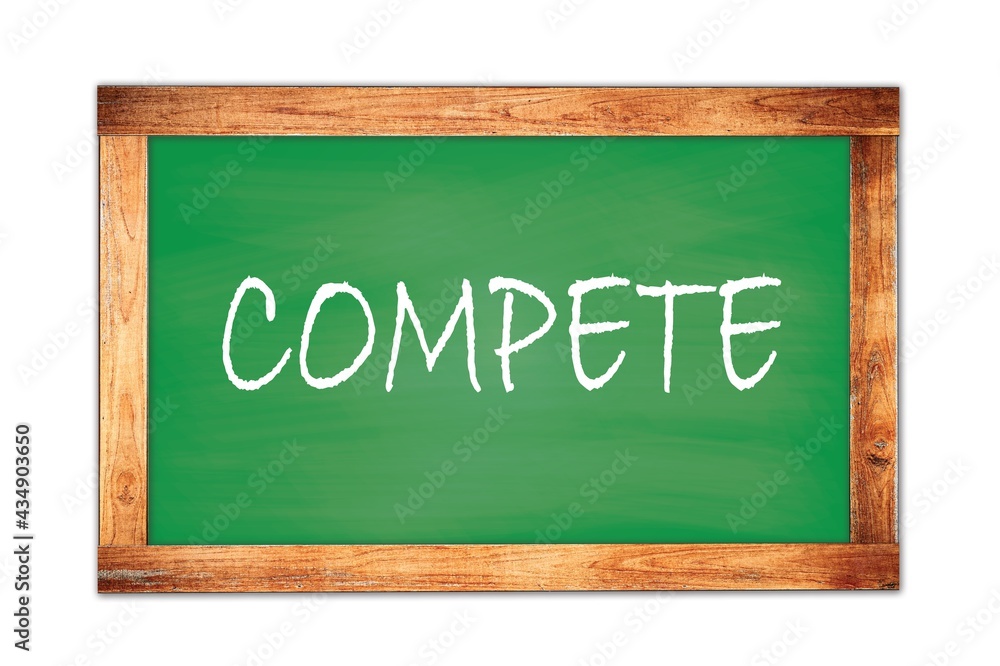 COMPETE text written on green school board. COMPETE text written on green school board.