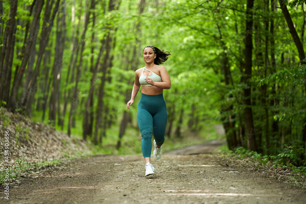 Plus size runner woman in the forest Plus size runner woman in the forest