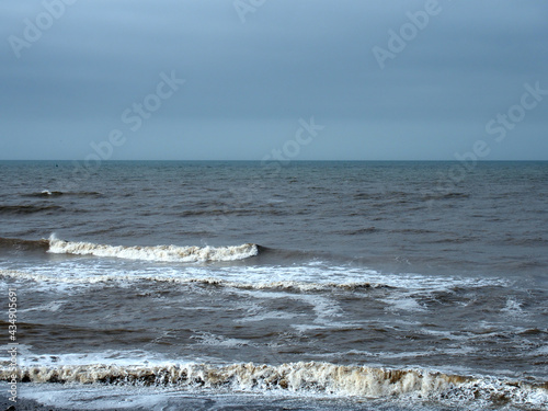 seascape with deep blue ocean and surf breaking on the beach