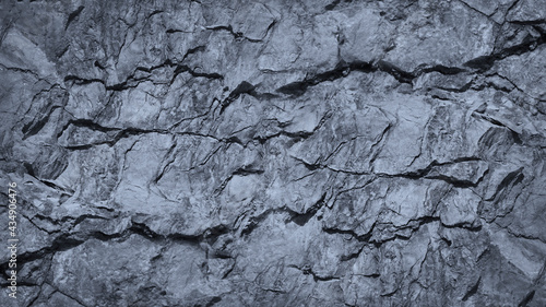 Gray rock texture with cracks. Stone wall background with copy space for text and design. Wide banner. Rocky surface. Close-up.