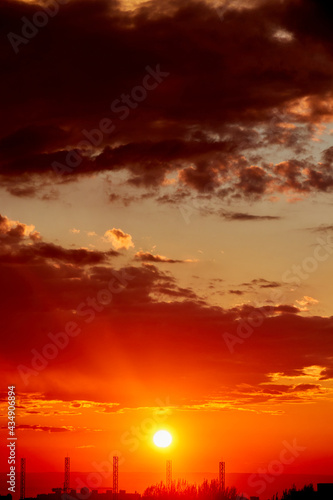 background of red dramatic beautiful sunset over the city © Temir