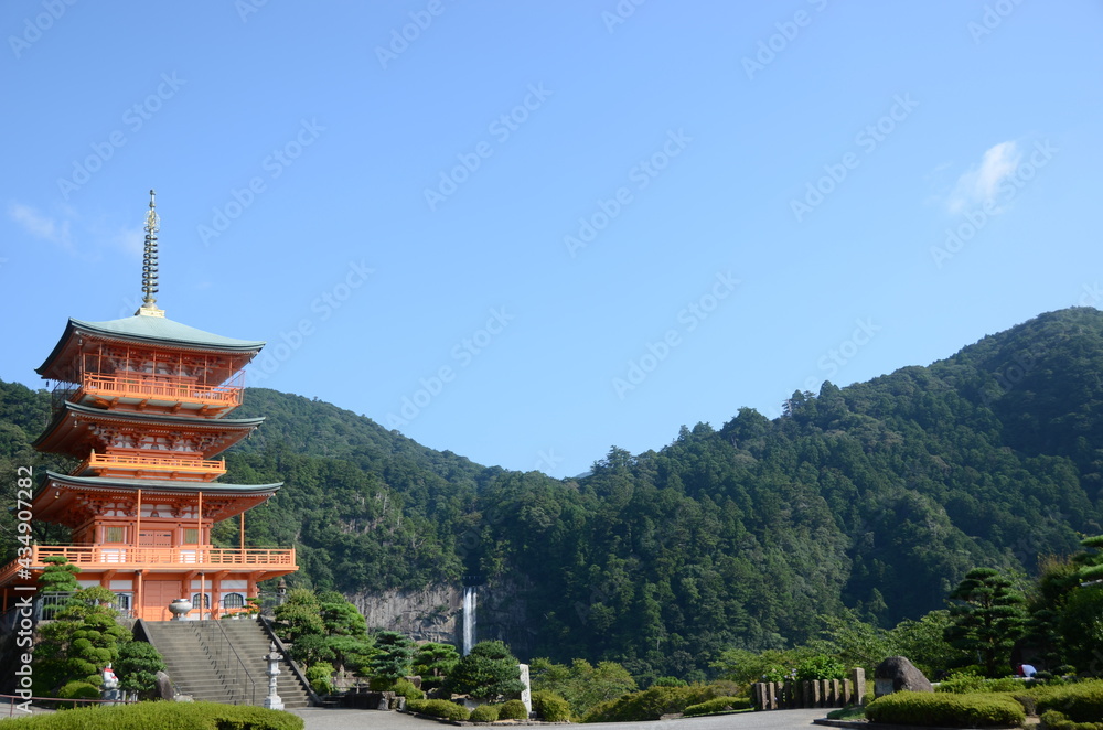 Kumano nachi taisha shrine with waterfall along in view Kumano nachi taisha shrine with waterfall along in view
