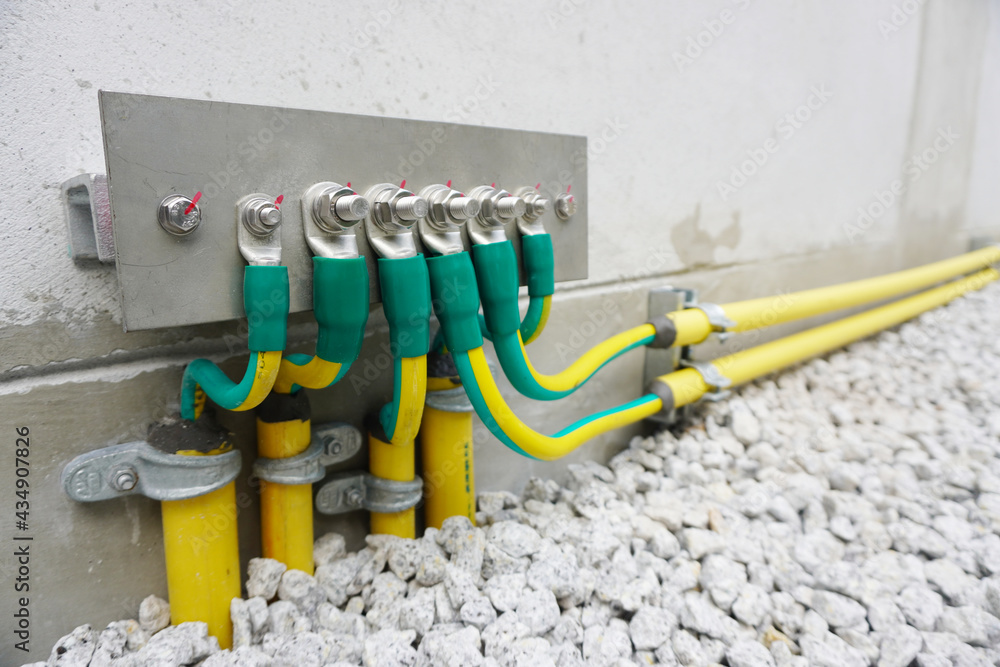 Electrical high voltage ground copper bar on wall. Grounding electric