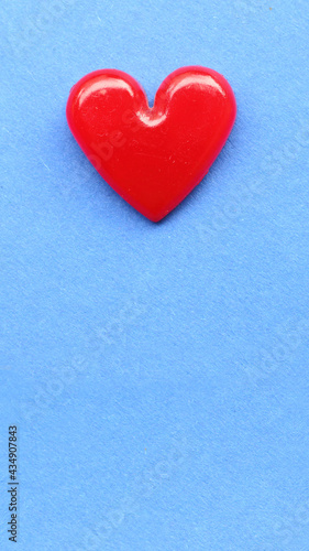 Red heart on blue paper. Background on health care or love theme.