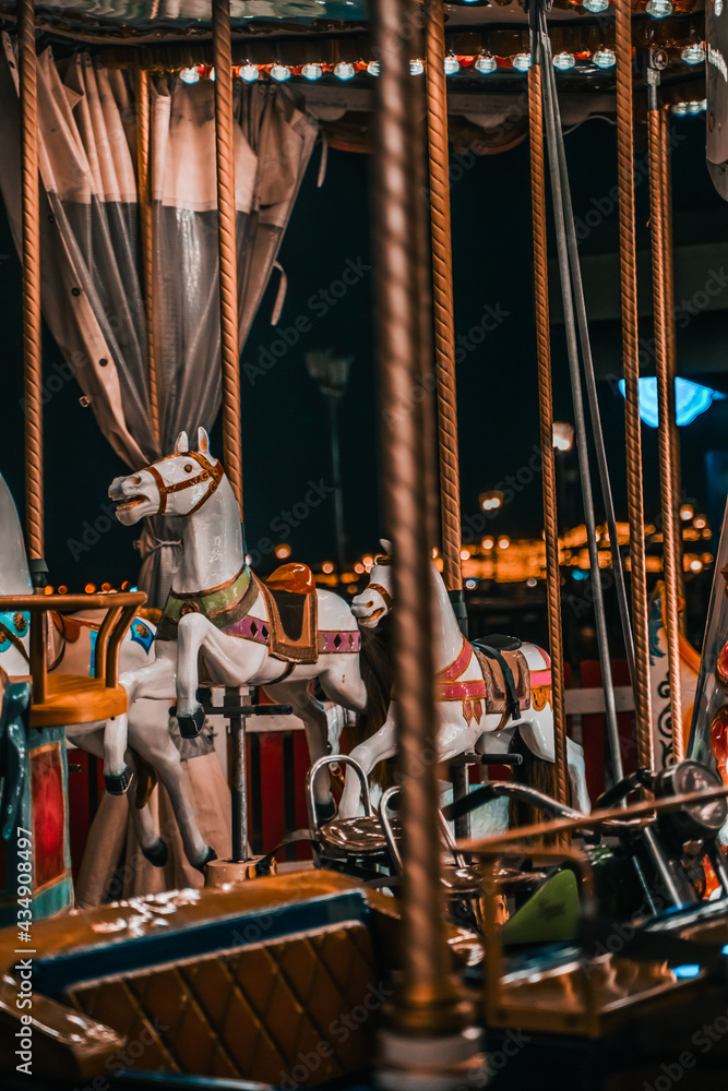 Children's carousel and glowing lights at night. Kazan, Russia - 8 May 2021