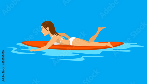 woman surfer swimming on surfboard