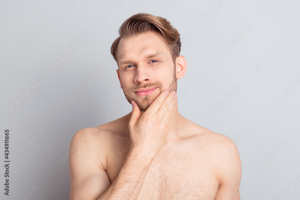 © deagreez - Portrait of attractive cool groomed guy touching chin sensual everyday care isolated over grey pastel color background