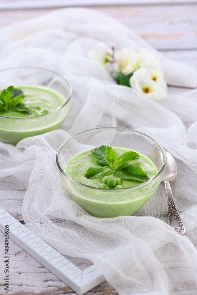 Chilled green pea puree soup with tender milk cream and refreshing mint Chilled green pea puree soup with tender milk cream and refreshing mint