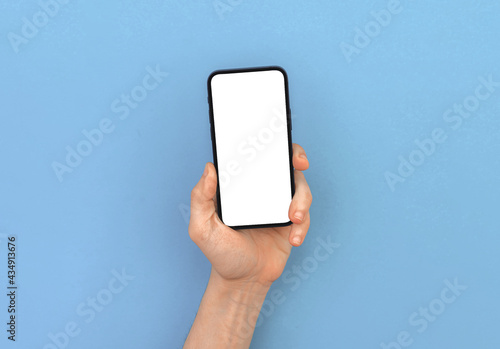 Man hand holds modern mobile phone mockup on bright pastel and colorful background, copy space