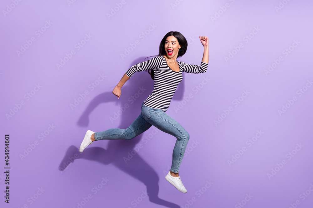 Full size profile side photo of young funky cheerful woman running fast look copyspace isolated on violet color background