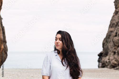 beautiful woman white dressed in a pebble beach