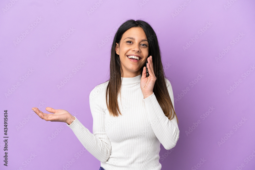 Young caucasian woman isolated on purple background keeping a conversation with the mobile phone with someone Young caucasian woman isolated on purple background keeping a conversation with the mobile phone with someone