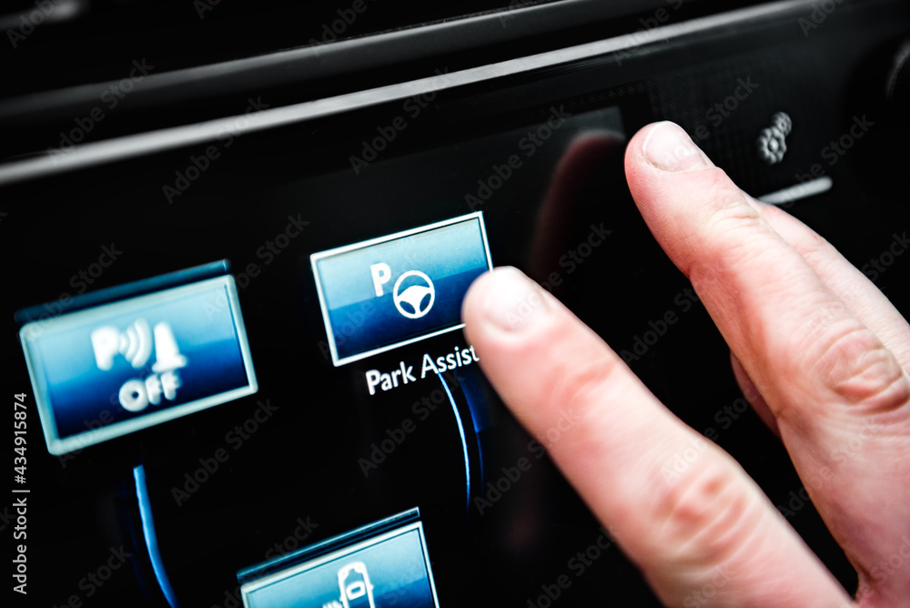Hand presses сar parking aid system button. Hand presses сar parking aid system button.