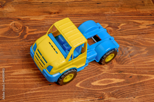 Toy truck on wooden background close up