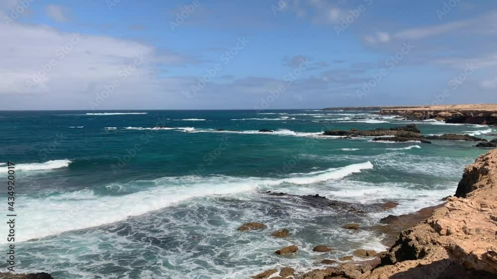 Rocky shore of Fuerteventura with ocean waves hitting the coast. Rocky shore of Fuerteventura with ocean waves hitting the coast.