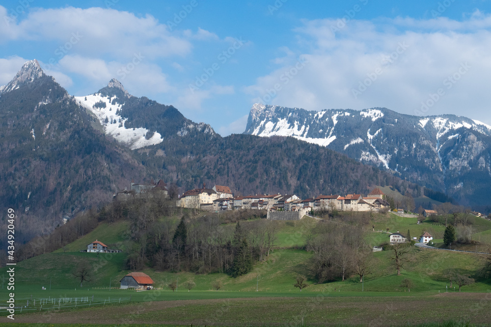 Historic town and Chateau de Gruyeres, Switzerland, in front of the mountains
