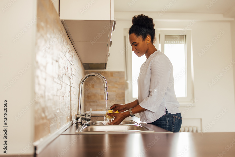 Woman using water and detergent, cleaning dishes. Woman using water and detergent, cleaning dishes.